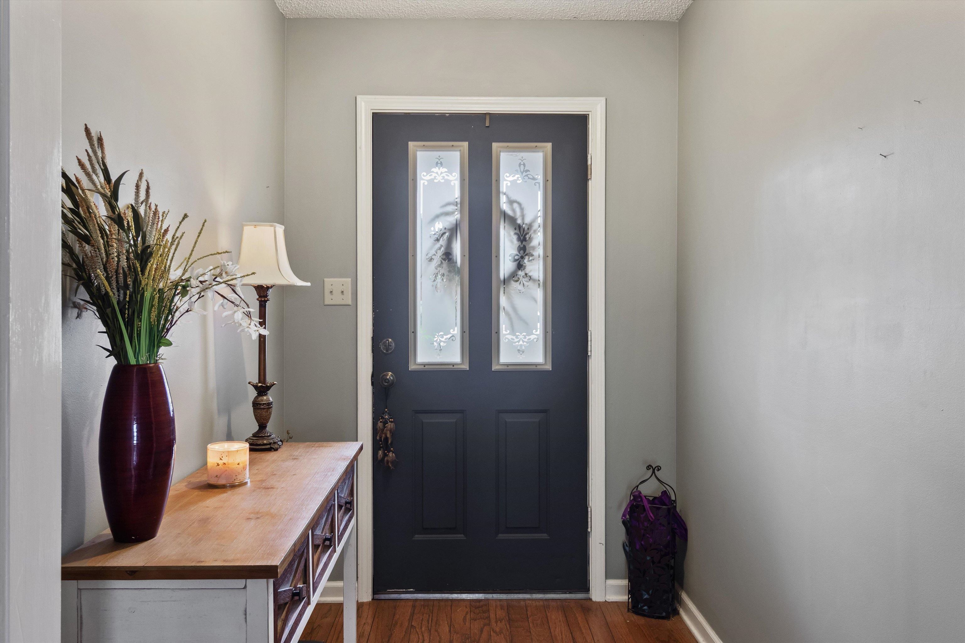 6712 Booth Forrest Drive Bartlett, TN 38135 - Photo 5 of 27 a view of a hallway with wooden floor and a potted plant