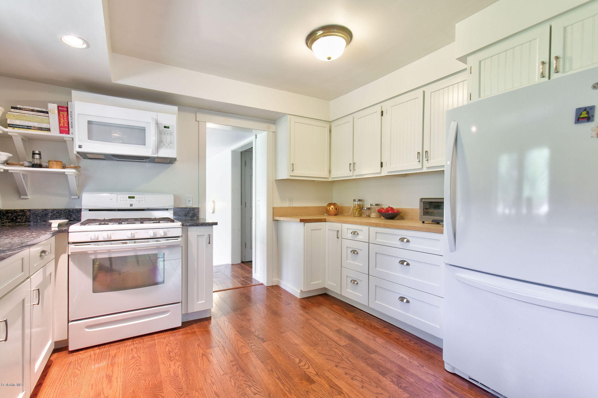 15 Beech Road Richmond, MA 01201 - Photo 22 of 48 a kitchen with granite countertop white cabinets and white appliances