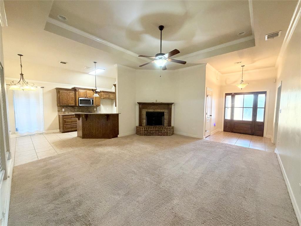 513 Fox Cove Haughton, LA 71037 - Photo 2 of 15 an empty room with fireplace and windows