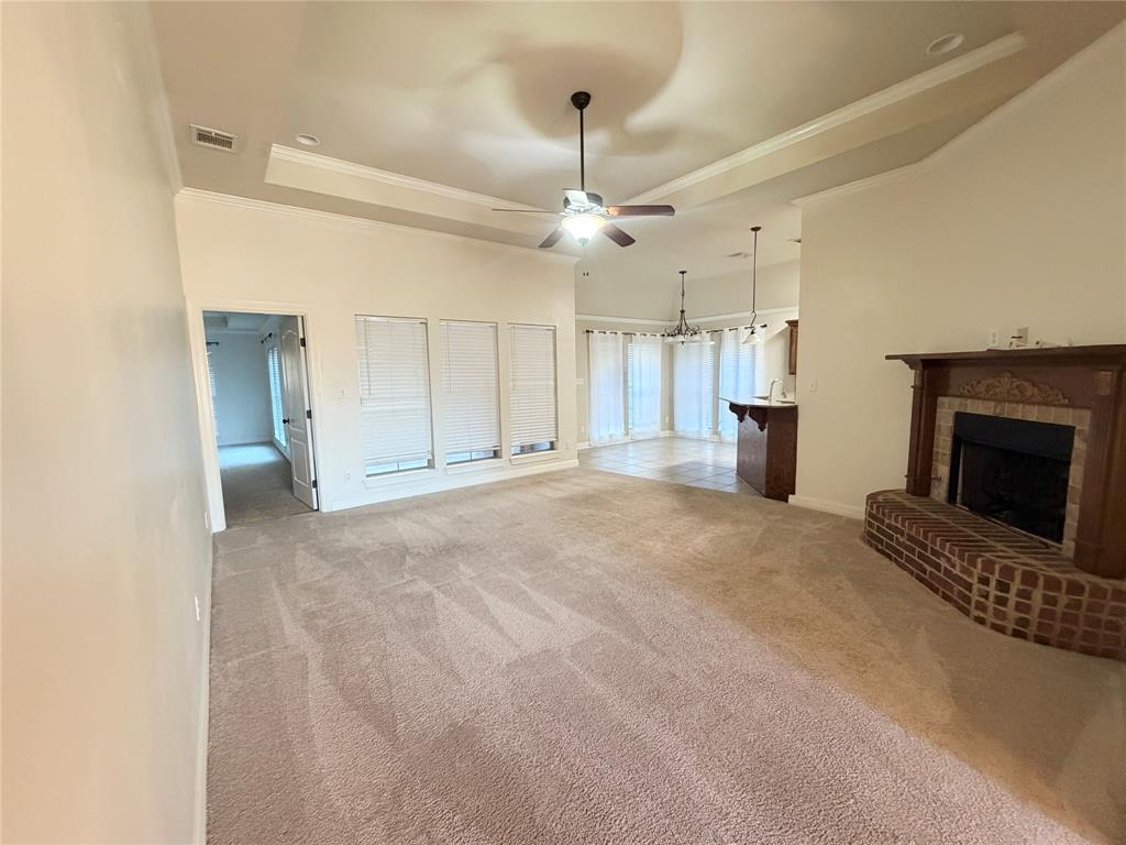 513 Fox Cove Haughton, LA 71037 - Photo 3 of 15 a view of a livingroom with a fireplace and a ceiling fan
