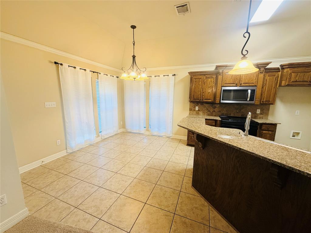 513 Fox Cove Haughton, LA 71037 - Photo 5 of 15 a kitchen with stainless steel appliances a stove top oven and cabinets