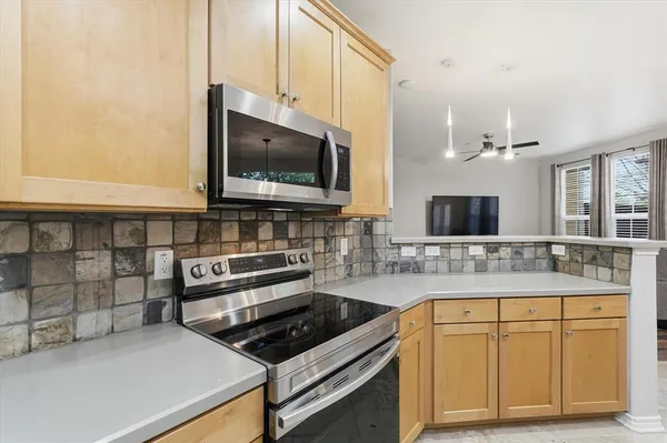 a kitchen with sink stove and microwave
