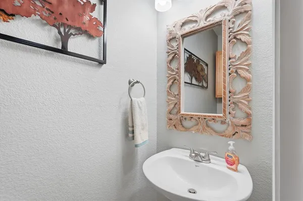 a bathroom with a sink and mirror