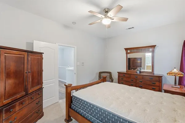 a bedroom with a bed and a dresser