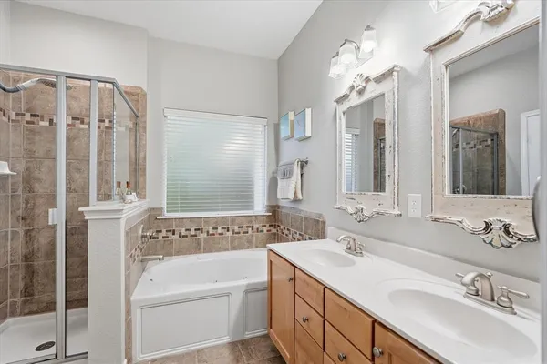 a bathroom with a tub sink and mirror