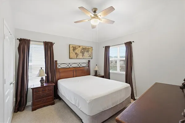 a bedroom with a large bed and a chandelier