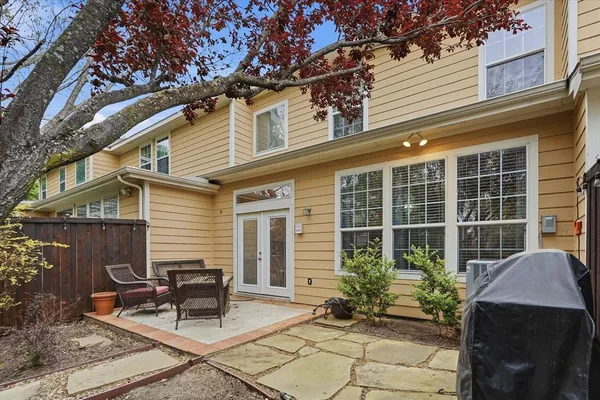 a view of a patio with table and chairs and potted plants