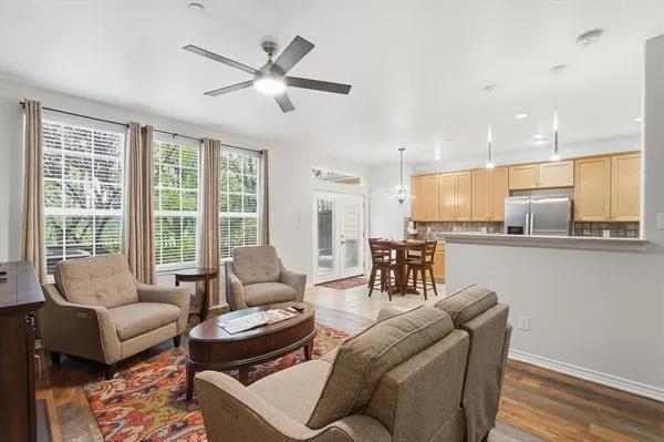 a living room with furniture and kitchen view