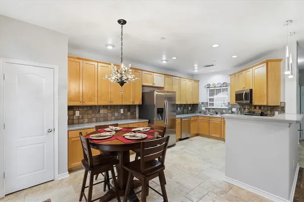 a kitchen with a table chairs sink and microwave