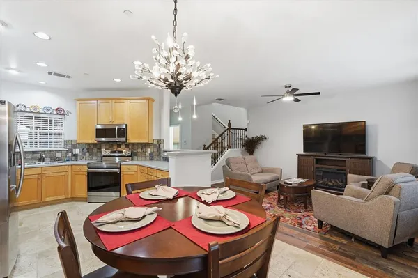 a living room with fireplace furniture and a flat screen tv