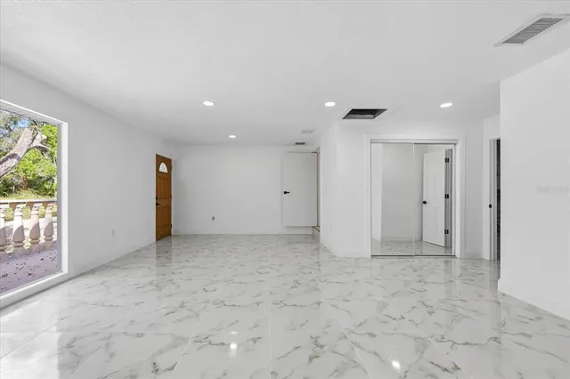 a bathroom with a granite countertop toilet sink and mirror