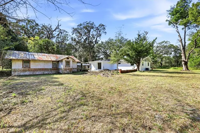 a view of a white house with a patio