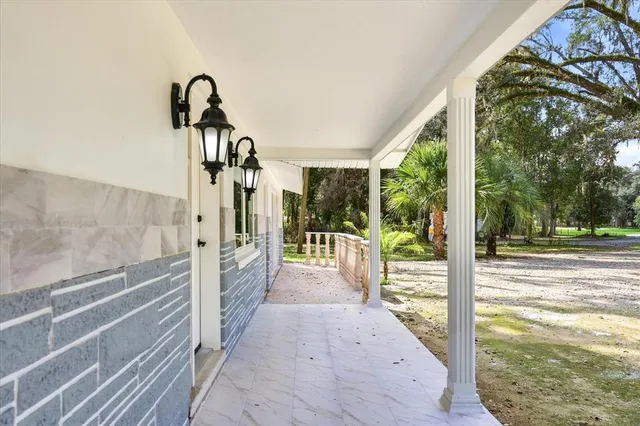 a front view of house with a garden and deck