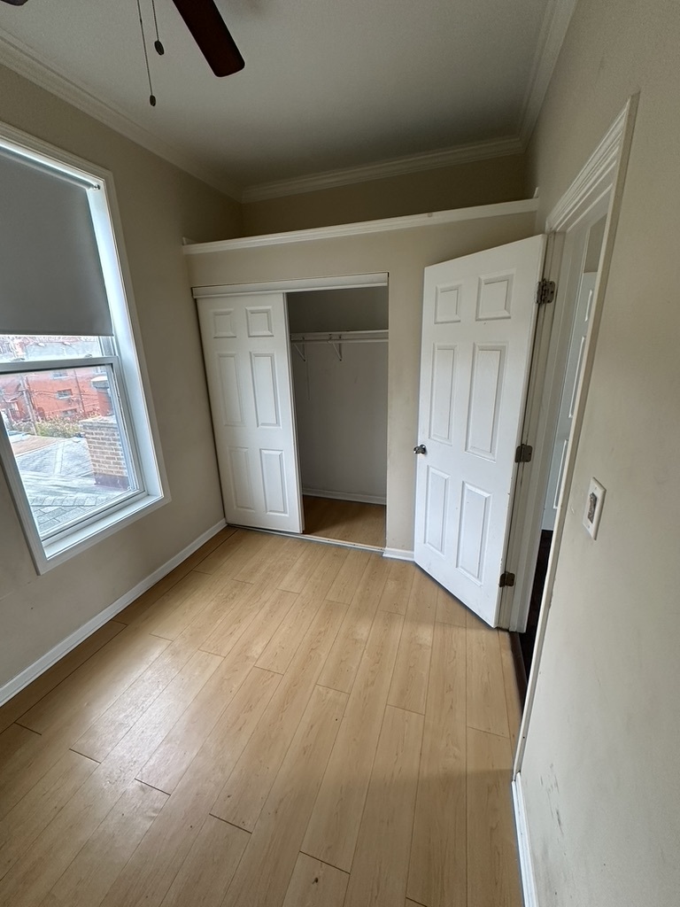 321 West 24th Street, Unit 3R Chicago, IL 60616 - Photo 10 of 11 a view of an empty room with wooden floor