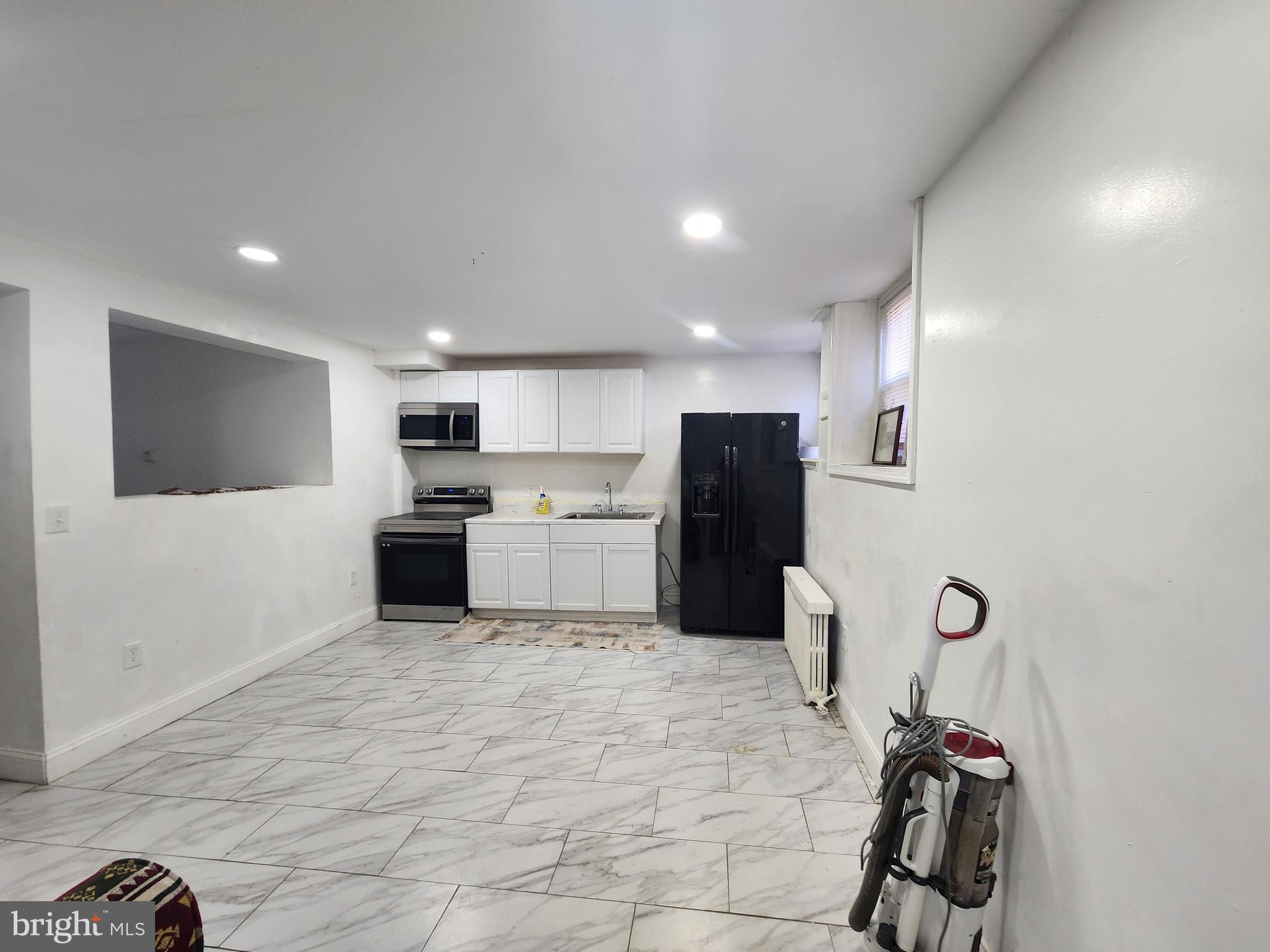 3507 Pelham Avenue Baltimore, MD 21213 - Photo 15 of 36 a kitchen with refrigerator and microwave
