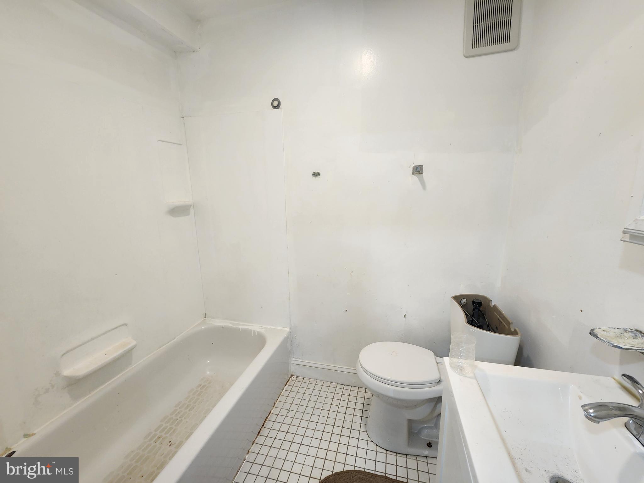 3507 Pelham Avenue Baltimore, MD 21213 - Photo 19 of 36 a bathroom with a toilet and a shower
