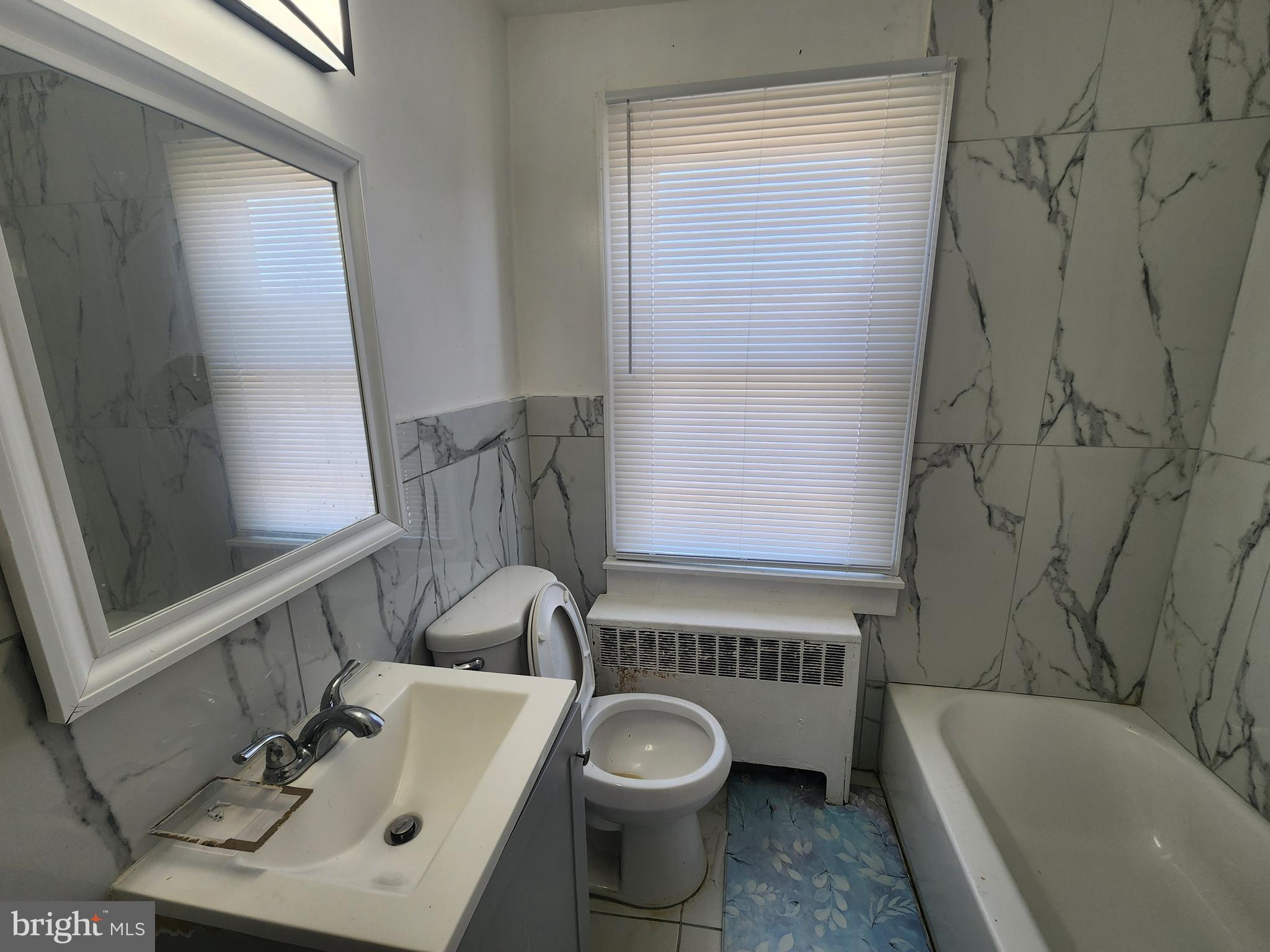 3507 Pelham Avenue Baltimore, MD 21213 - Photo 26 of 36 a bathroom with a sink a toilet and bathtub