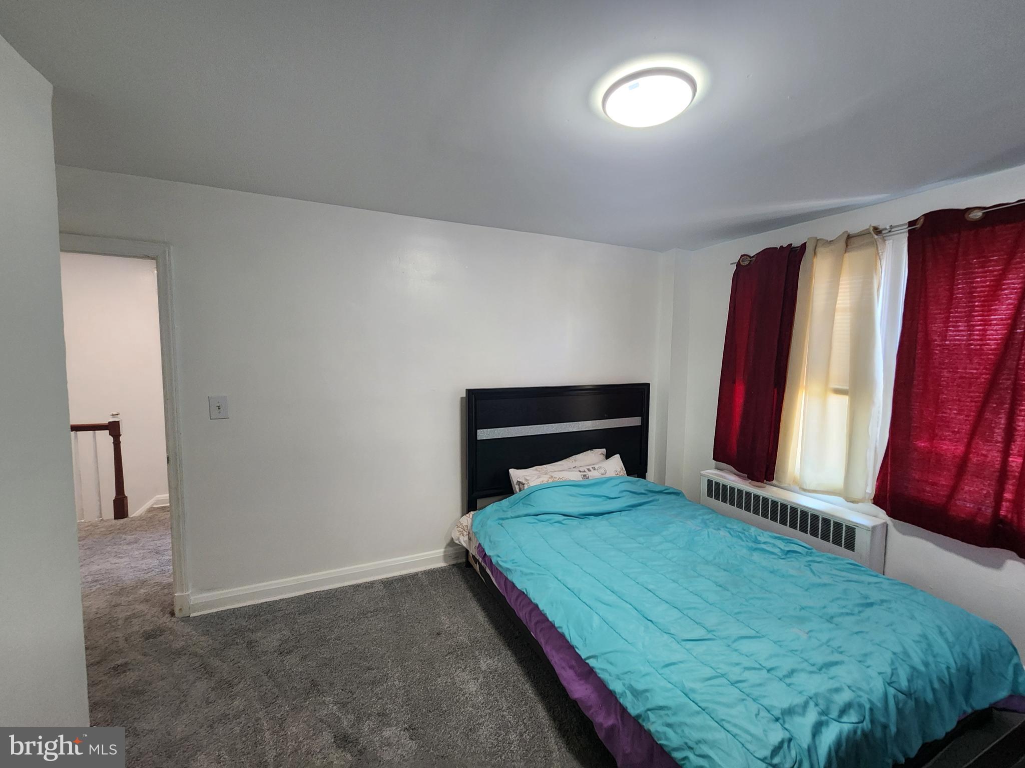 3507 Pelham Avenue Baltimore, MD 21213 - Photo 31 of 36 a bedroom with a bed and a mirror