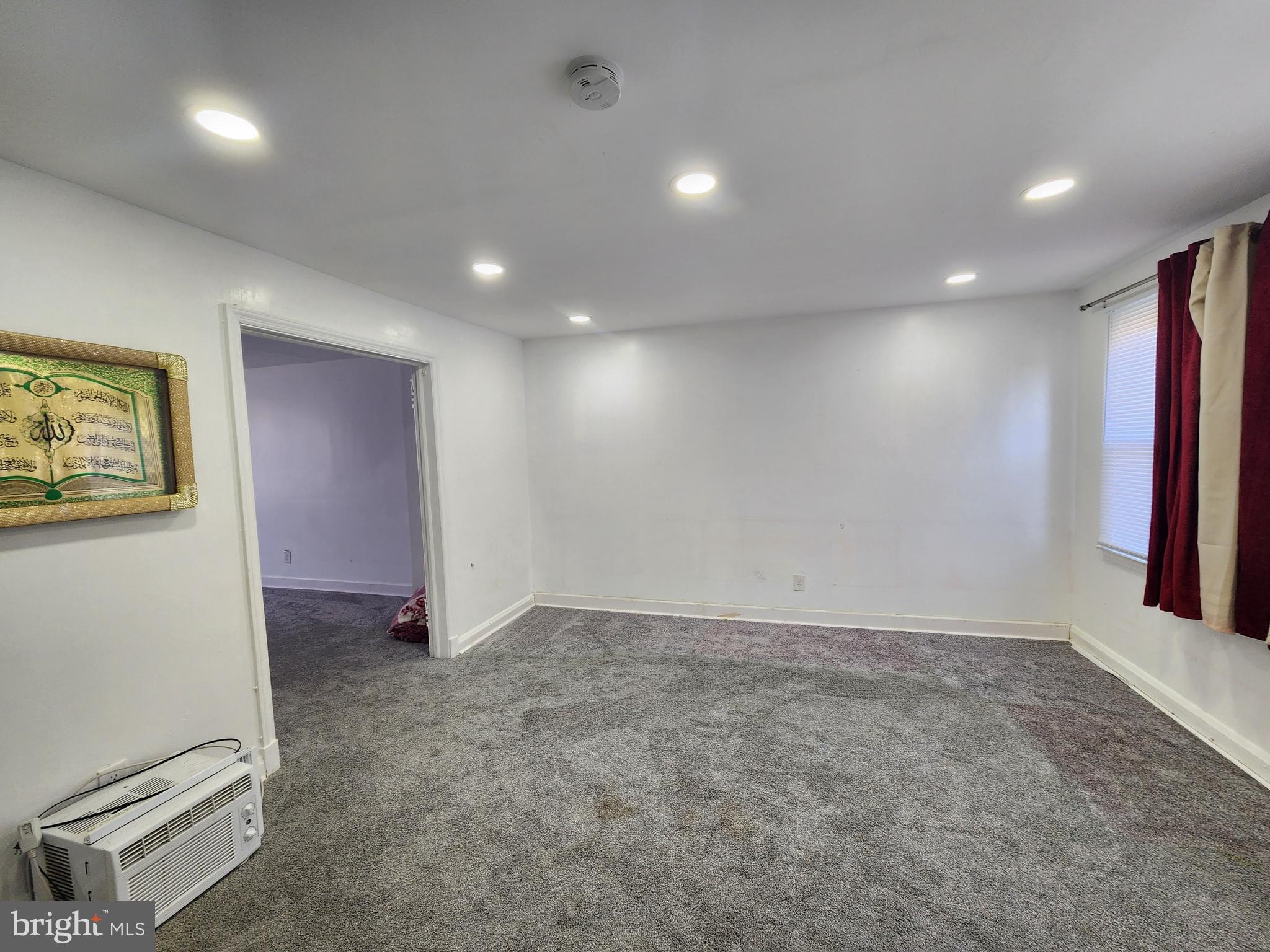 3507 Pelham Avenue Baltimore, MD 21213 - Photo 7 of 36 an empty room with a projector and white walls