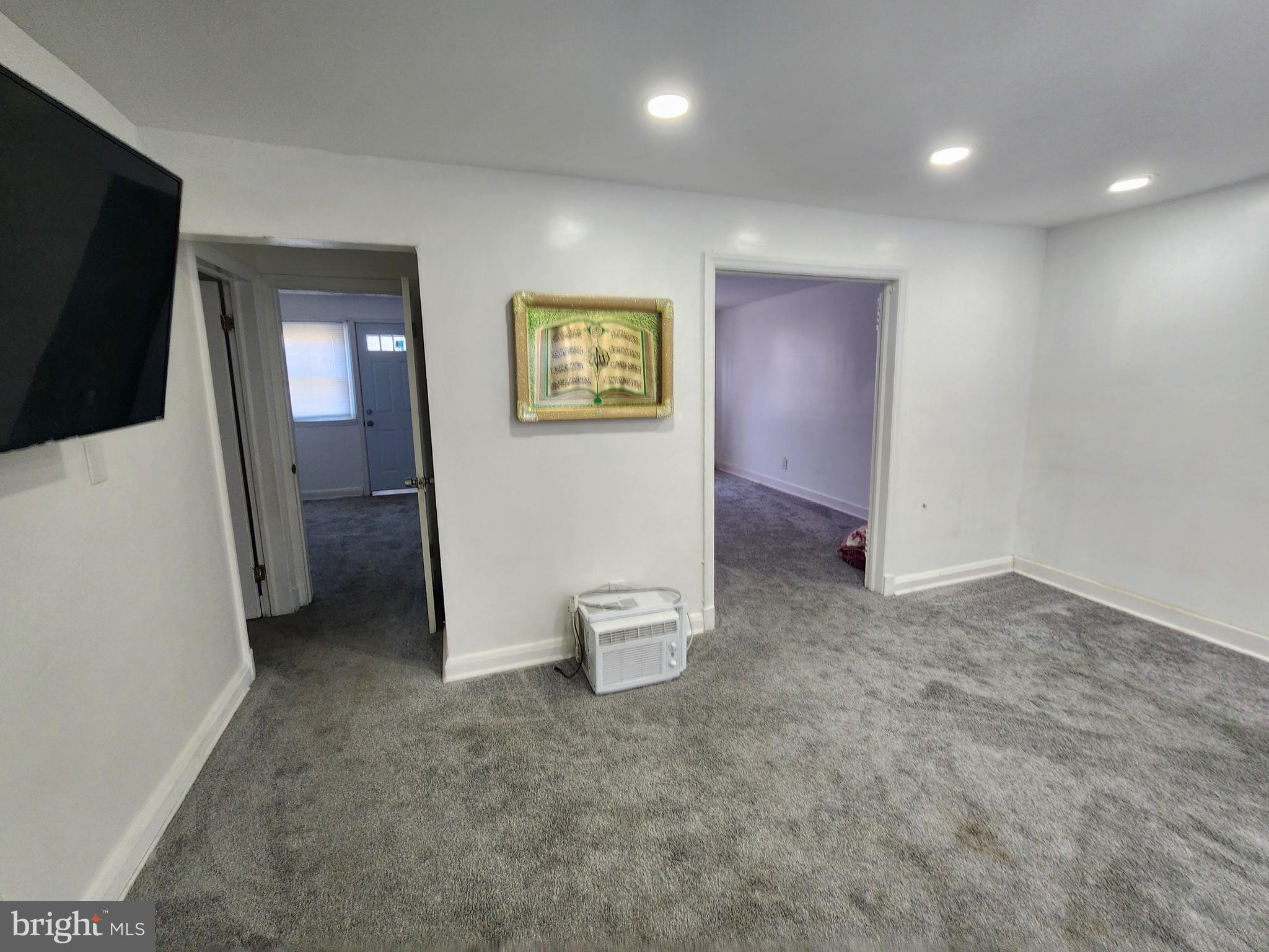 3507 Pelham Avenue Baltimore, MD 21213 - Photo 8 of 36 a view of hallway with stairs and a flat screen tv