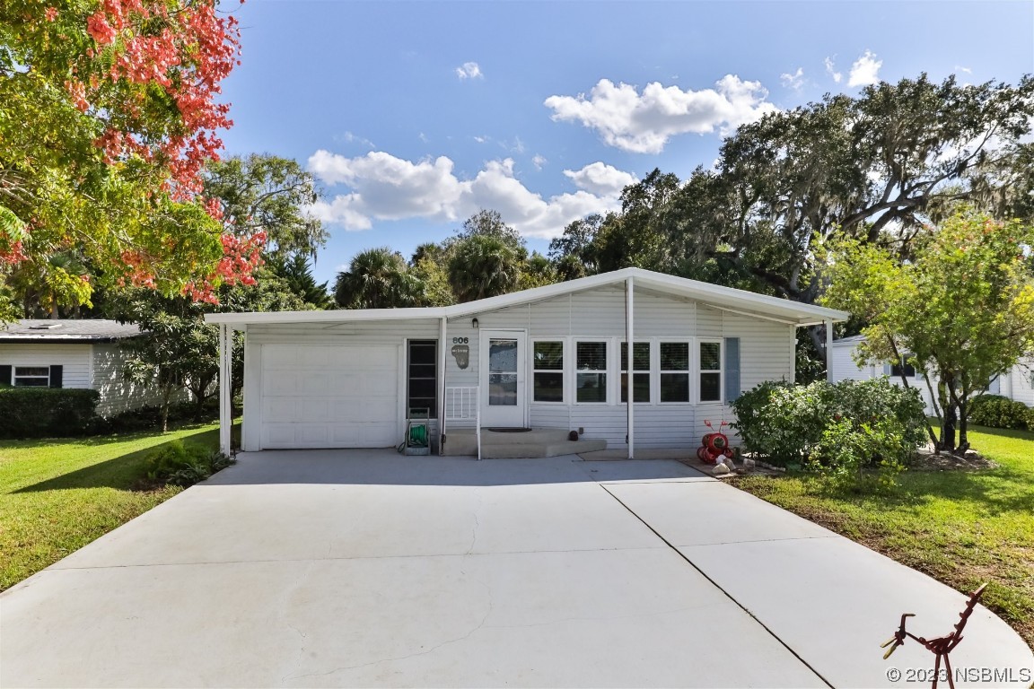 806 Navigators Way Edgewater, FL 32141 - Photo 1 of 59 a front view of a house with garden