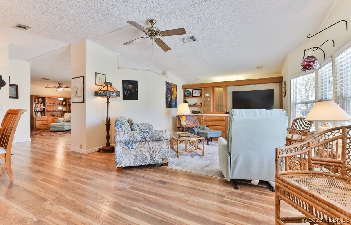 806 Navigators Way Edgewater, FL 32141 - Photo 14 of 59 a living room with furniture and a wooden floor