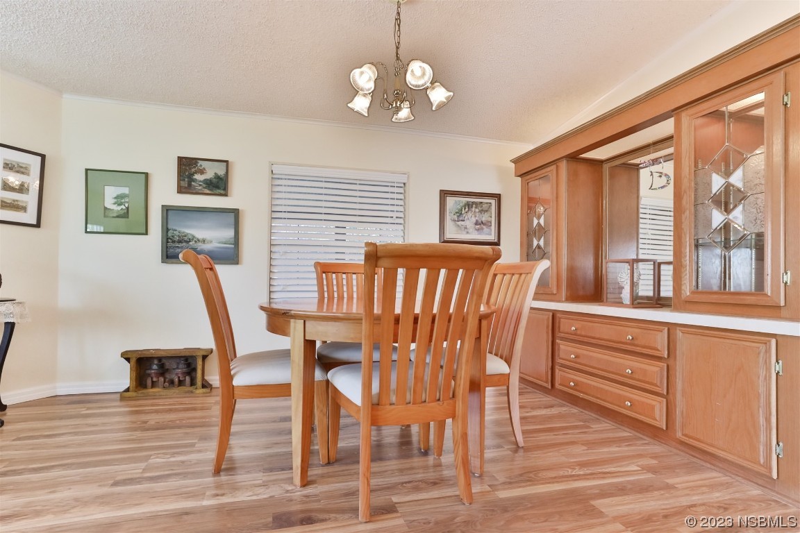 806 Navigators Way Edgewater, FL 32141 - Photo 17 of 59 a view of a dining room with furniture wooden floor and chandelier
