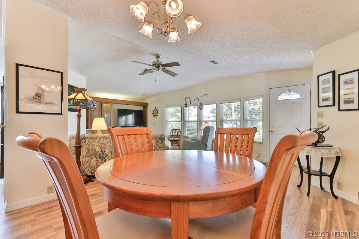 806 Navigators Way Edgewater, FL 32141 - Photo 18 of 59 a dining room with furniture and wooden floor