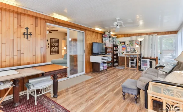 a view of a room with wooden floor and bathroom