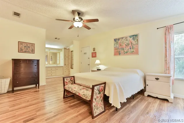 a room with furniture a ceiling fan and a wooden floor