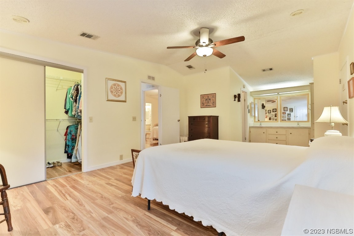 806 Navigators Way Edgewater, FL 32141 - Photo 29 of 59 a bedroom with a large bed and a chandelier