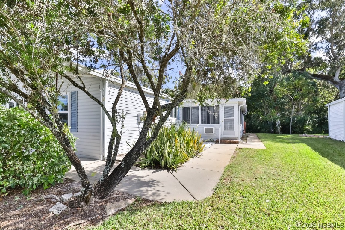 806 Navigators Way Edgewater, FL 32141 - Photo 4 of 59 a front view of a house with garden