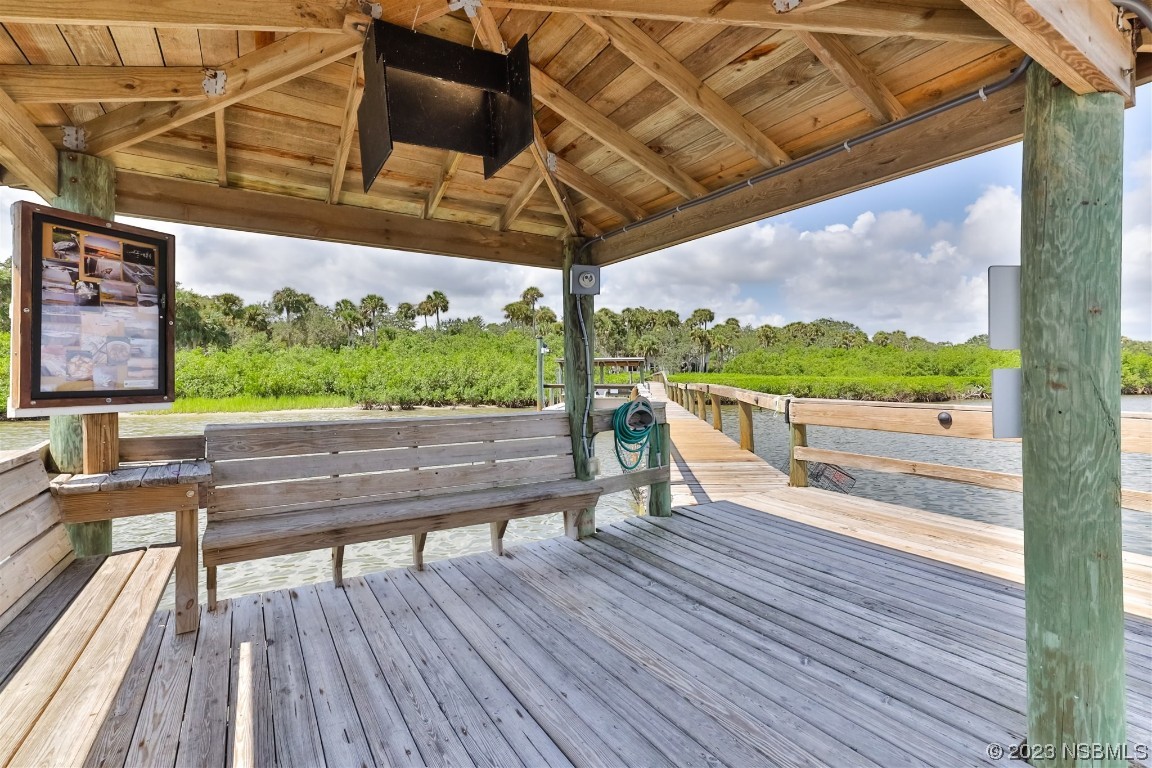 806 Navigators Way Edgewater, FL 32141 - Photo 44 of 59 a view of a wooden deck with a bench