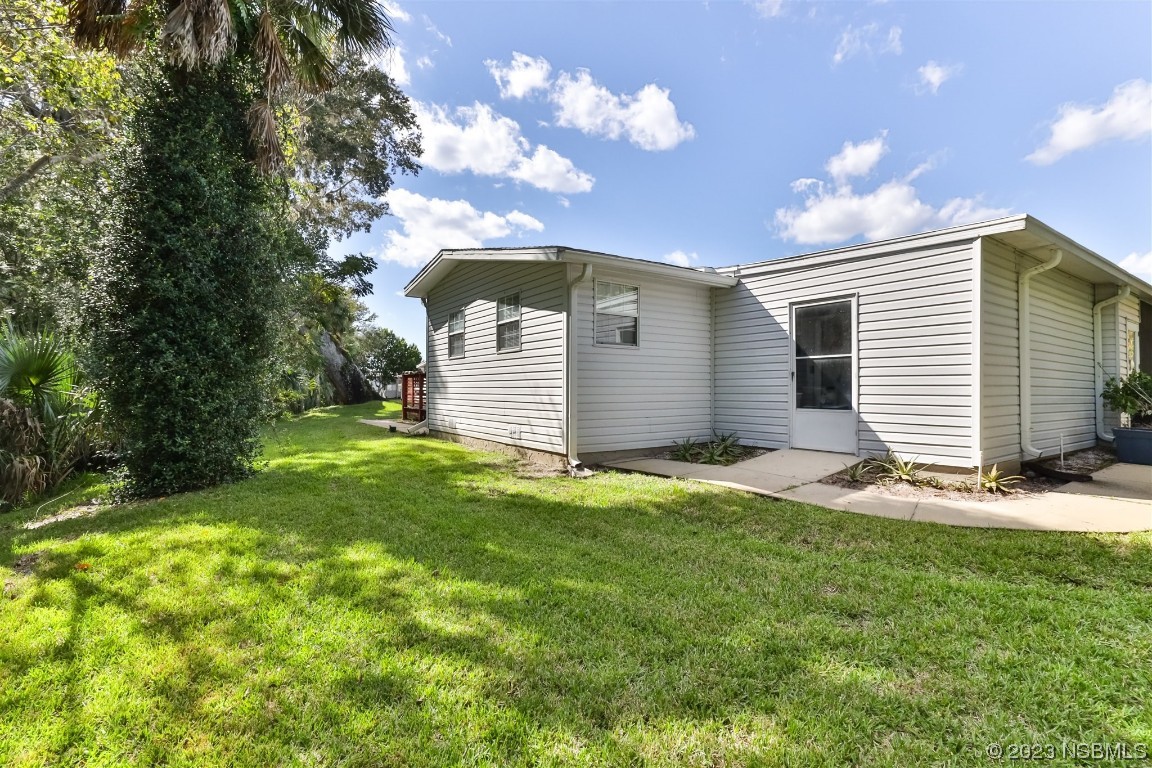 806 Navigators Way Edgewater, FL 32141 - Photo 10 of 59 a view of a house with a yard and garage