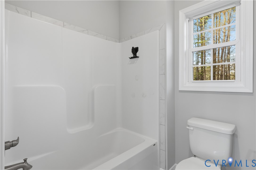 7501 Military Road Amelia Court House, VA 23002 - Photo 25 of 29 Primary bathroom, tub, shower, linen closet, tile