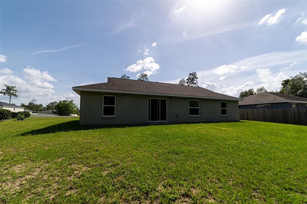 5107 Southwest 165th St Road Ocala, FL 34473 - Photo 32 of 34 a yellow house with garden in front of it