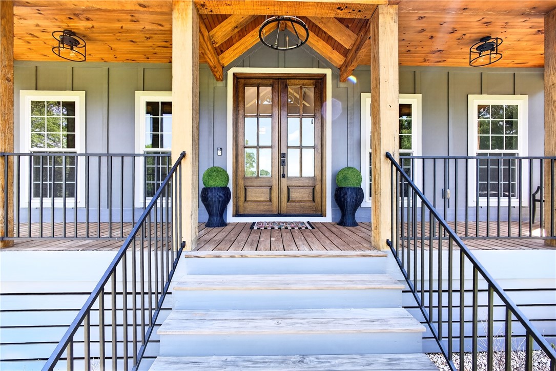 5016 Copeland Road Belton, SC 29627 - Photo 4 of 45 A welcoming wooden porch entry with double doors and charming rustic accents.