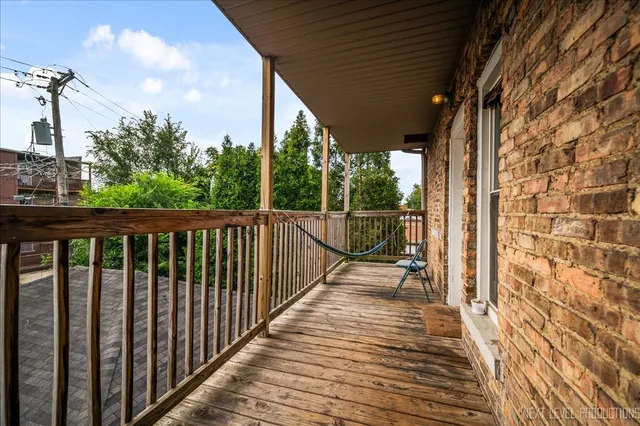 a view of a balcony with wooden floor