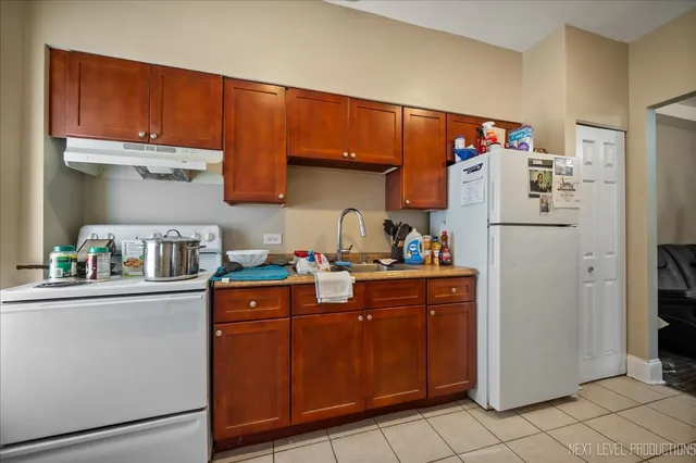 a kitchen with stainless steel appliances granite countertop a refrigerator stove and sink