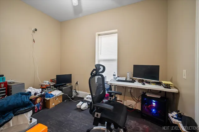 a view of a workspace with furniture and a window