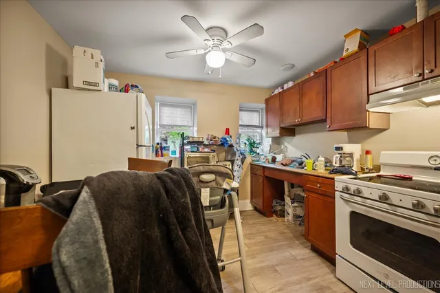 a kitchen with stainless steel appliances granite countertop a stove a sink dishwasher and a refrigerator