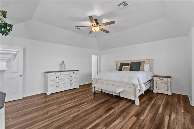 a bedroom with a bed and a dresser