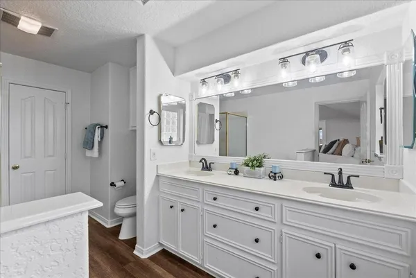 a bathroom with a double vanity sink mirror double and shower