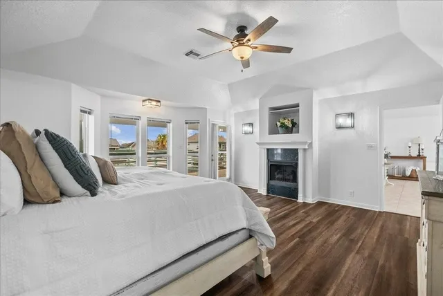 a bedroom with a large bed and a chandelier