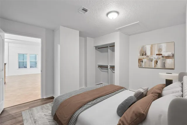 a bedroom with a bed and a window