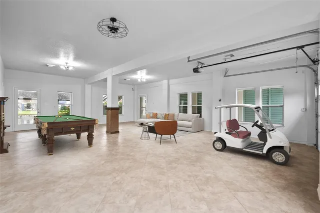 a living room with furniture gym equipment and view of kitchen