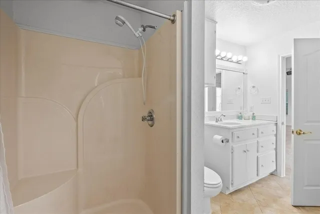 a bathroom with a shower sink and mirror