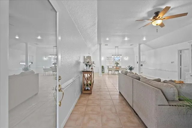 a large white kitchen with lots of counter space and a sink