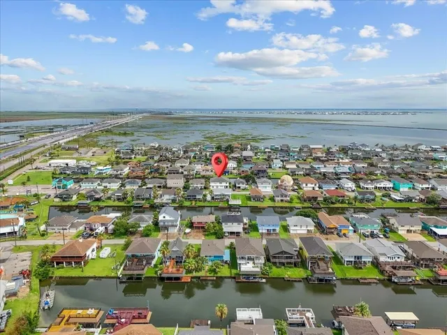 an aerial view of a house with a garden and lake view