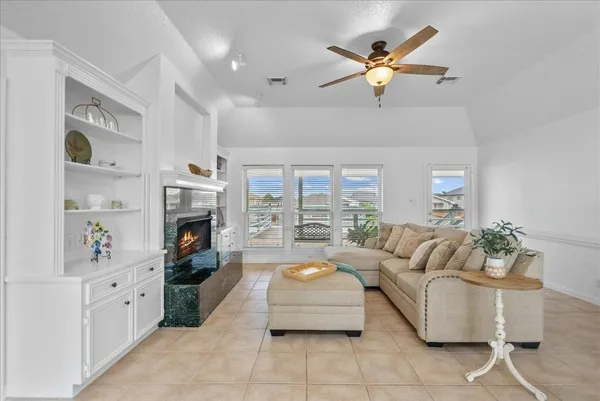 a living room with furniture fireplace and a chandelier